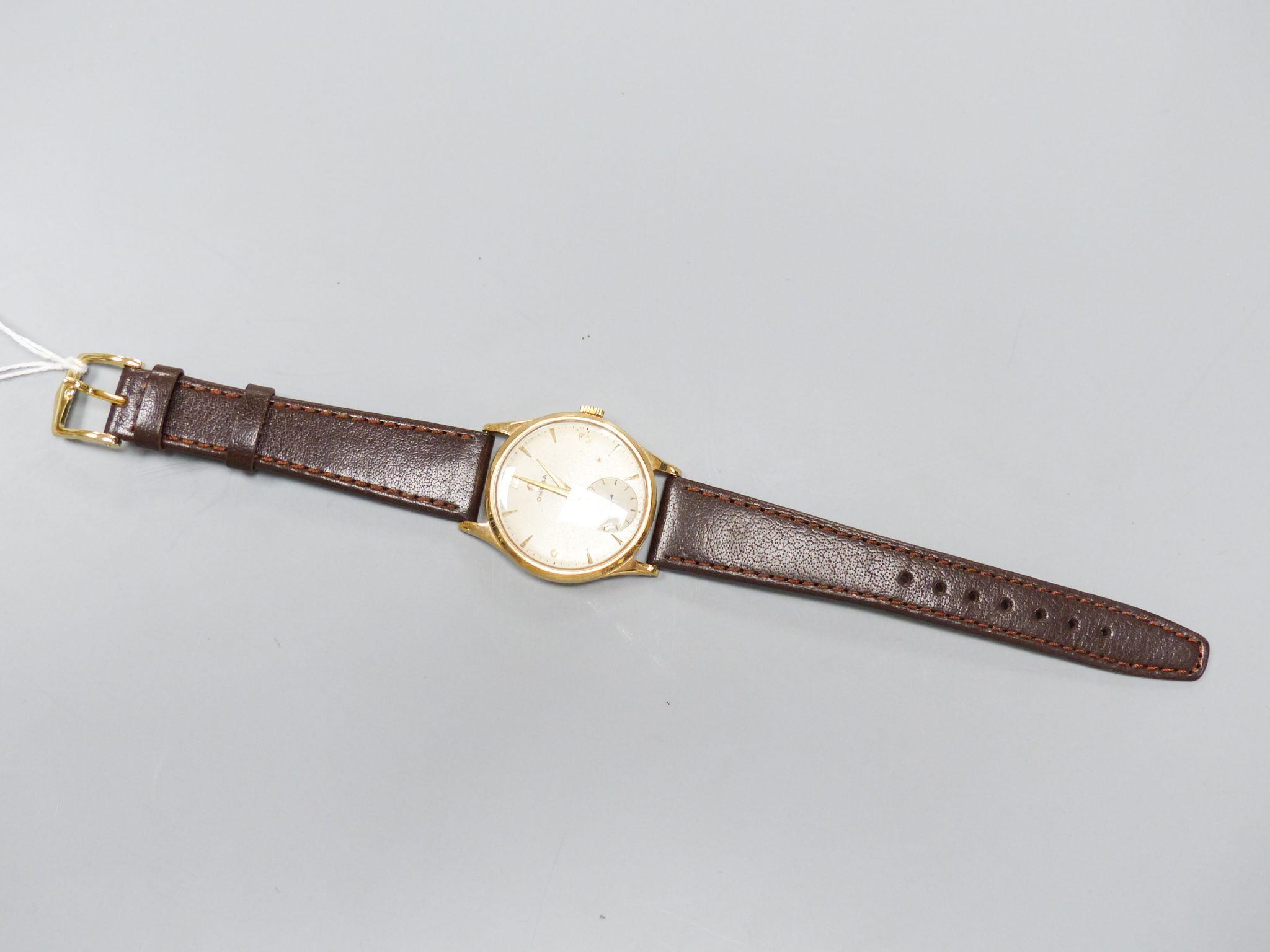 A gentleman's 1950's 9ct gold Omega manual wind wrist watch, movement c.266, on associated strap, cased diameter 33mm, gross weight 36 grams.